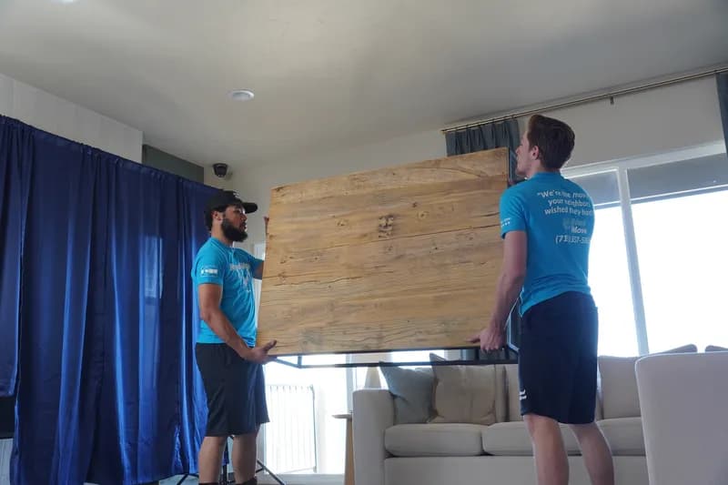 Professional team lifting furniture